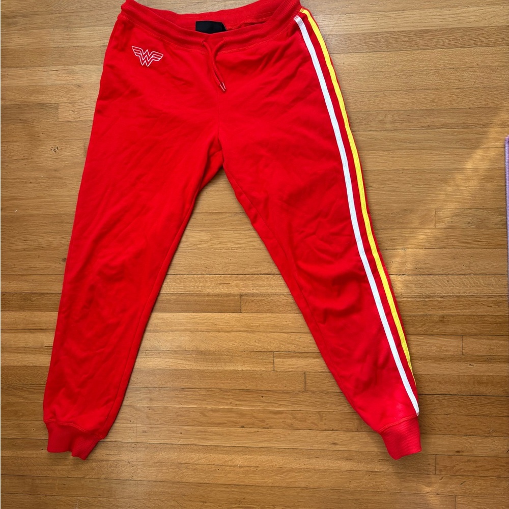 Wonder Woman DC red sweats with side stripes on one side.